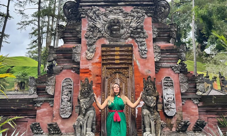 Delfina at a temple gate, arms open