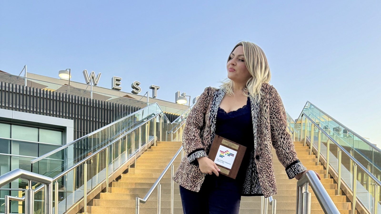 Delfina holding a City of West Hollywood recognition